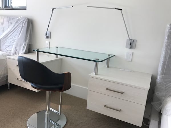 Floating side tables and glass desk from Valet Custom Cabinets & Closets