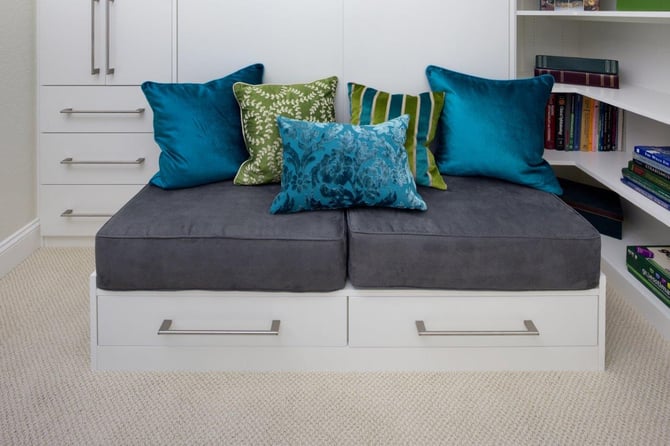 Using a wall bed with a bench seat gives extra storage to a kid’s bedroom.