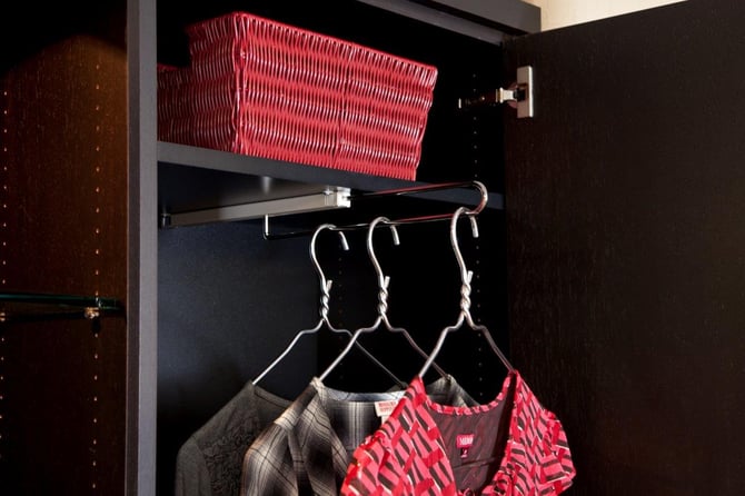 Cabinets with pull-out hanging rods keep clothing storage nice and compact.