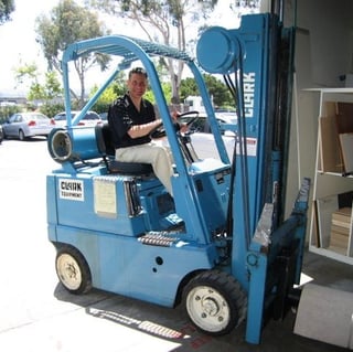 Larry on a forklift in the warehouse