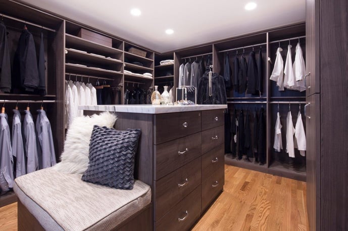 Walk-in closet with island and bench in Hudson finish